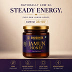 A jar of Shuddhta Jamun Honey centered on a beige background with promotional text above and feature icons below. The product is a dark amber glass jar with a gold lid and a deep purple label reading 'SHUDDHTA RAW, RARE & RICH JAMUN HONEY'.