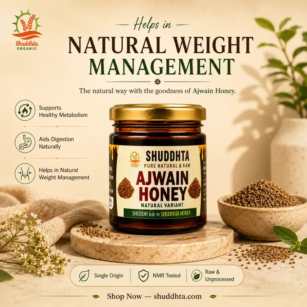 A jar of Shuddhda Pure Natural Ajwain Honey is displayed on a wooden stand in a styled kitchen setting with seeds, a bowl, and herbs. The image includes marketing text overlays detailing the health benefits of the honey.