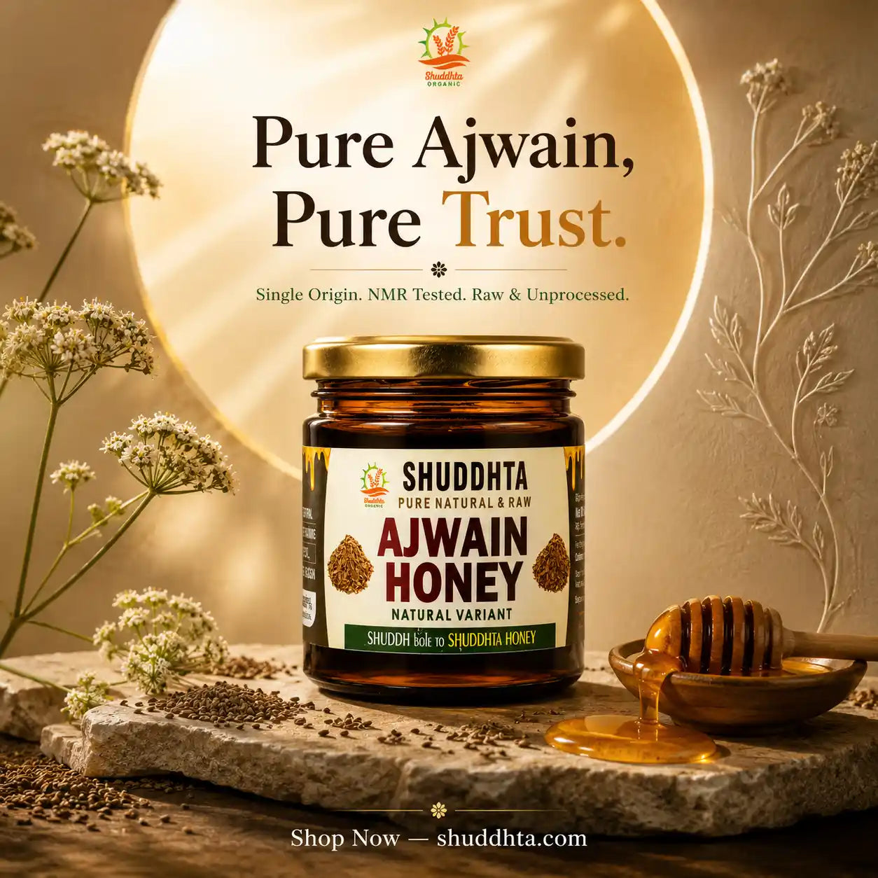 A jar of Shuddhta Pure Natural Raw Ajwain Honey is displayed on a rustic stone slab with a honey dipper and dried flowers. The background features a glowing golden circle with the text 'Pure Ajwain, Pure Trust.