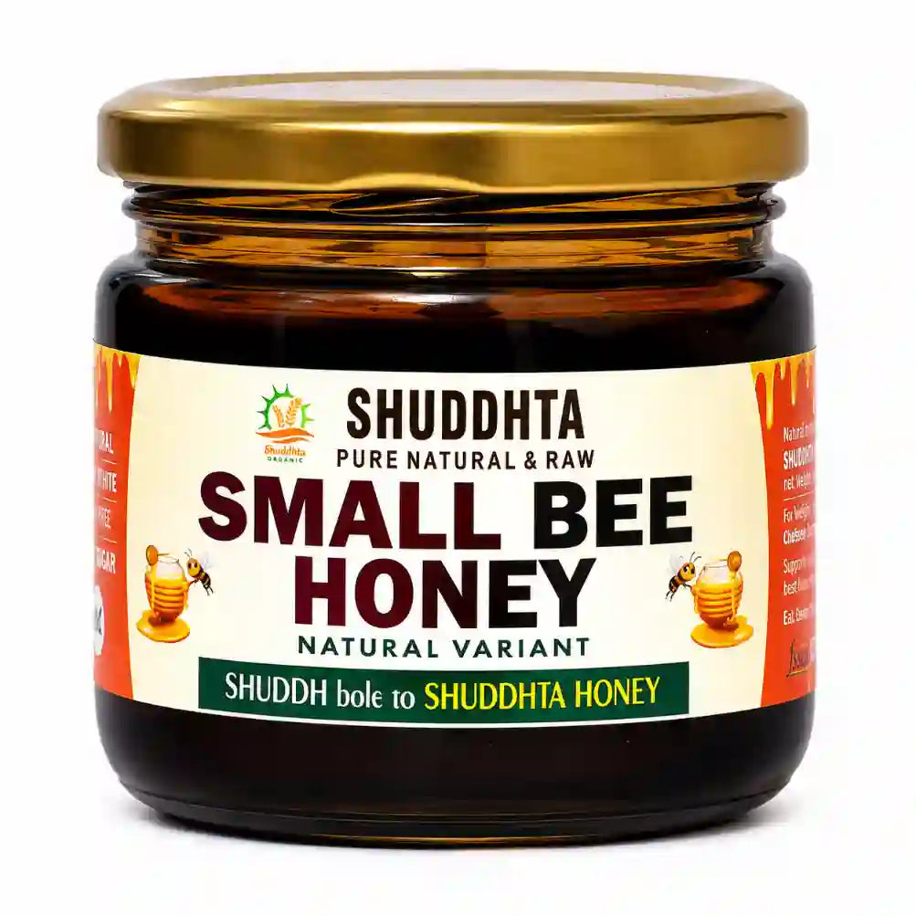 A jar of Shuddhta Small Bee Honey with a gold metal lid and a cream-colored label, set against a plain white background.